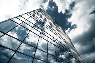 Glass high-rise reflecting clouds.