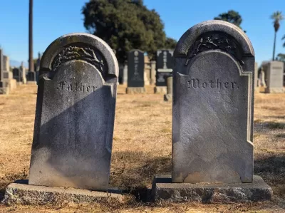 Cement gravestones reading Father and Mother