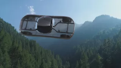 A conceptual rendering of a flying car, pictured in flight over mountains.