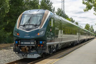 An Airo train driving towards the camera on a track. There is a forest behind it.