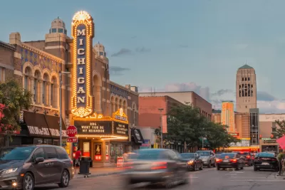 Cars are blurred as they pass the bright lights of the Michigan Theater at dusk in Ann Arbor.