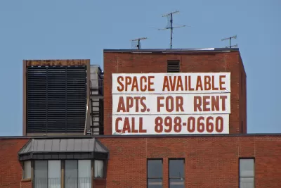 Large white banner with red letter reading "Space Available - Apts. for Rent - Call 898-0660" on brick building in Washington, D.C.