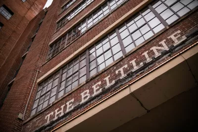 A sign reading Atlanta Beltline appears above the large doorway of a brick building.