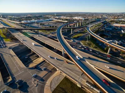 Aerial Texas Hill Country at sunset, with an aerial view of a highway interchange and Interstate 35 in Austin, Texas.