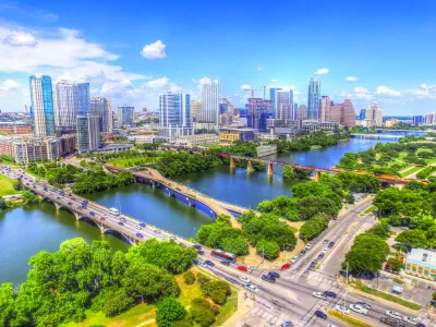 Multiple bridges busy with cars cross Lady Bird Lake outside downtown Austin, Texas.
