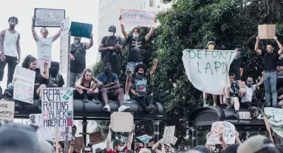 A group of protestors support Black Lives Matter and call for police reforms while gathered on top of a bus stop in Los Angeles.