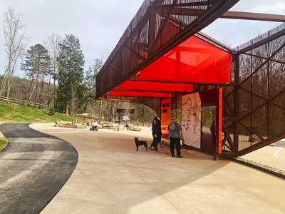 Red and black pavilion with visitor information in public park in Knoxville, Tennessee.