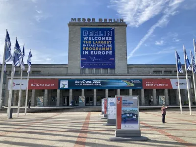 Banner welcoming Polish transit hub project at convention center in Berlin.