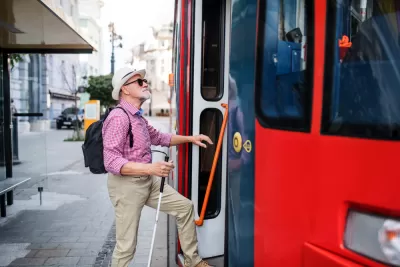 Man with visual impairment boarding public bus