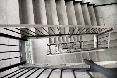 View looking down a multi-story apartment building staircase