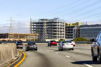 Several office towers are under construction next to a freeway in Burlingame, California.