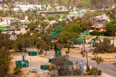 View of neighborhood with oil wells between houses