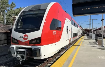 Red and white Caltrain electric train at platform in San Jose, California.