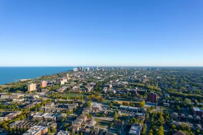 An aerial view of the South Side of Chicago, with Lake Michigan to the left in the distance. 