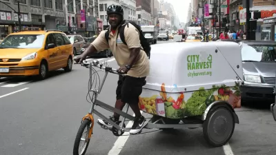 Man riding bike in New York with City Harvest cargo compartment attached