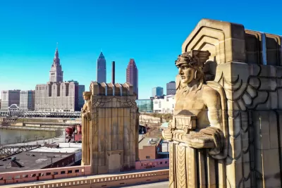 One of the "Guardians of Traffic" in Cleveland, a scuplture of a large figure adorning a bridge in Cleveland. Downtown Cleveland is in the background.