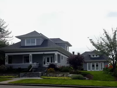 Craftsman-style two-story home with detached converted garage apartment accessory dwelling unit.