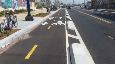 Bike lane in Washington D.C. protected by low concrete barriers.
