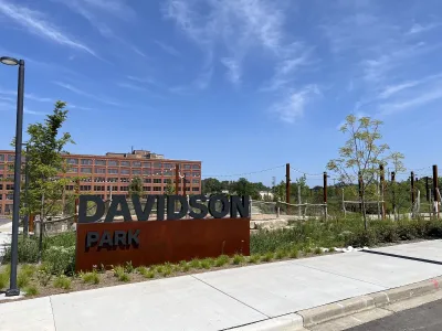 Entrance sign for Davidson Park next to Harley-Davidson HQ building in Milwaukee, Wisconsin.