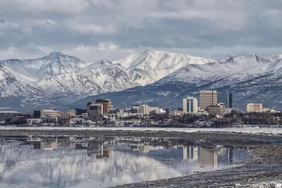 Downtown Anchorage with the snow covered Chugach Mountains in the background.