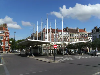 Bus station with thin white columns in Dunkirk, France.