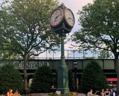 Historic clock surrounded by public seating in plaza in downtown Cranford, New Jersey.