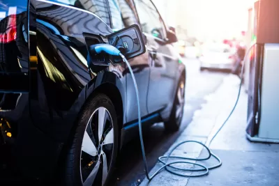 Electric car being charged at a station