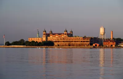 Ellis Island is shown across the water of the New York Harbor.