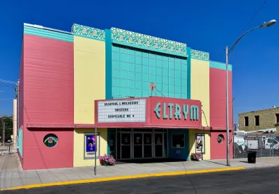 The Eltrym theater, a square building with light red, yellow and blue walls.