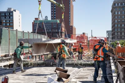 Workers in orange vests work on replacing Park Avenue Viaduct.