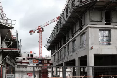 Cranes rise into the sky on a construction site for an office and housing building for the Bouygues Group in the southern suburbs of Paris.