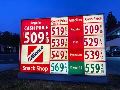 A sign showing gas prices, all at more than $5 a gallon.