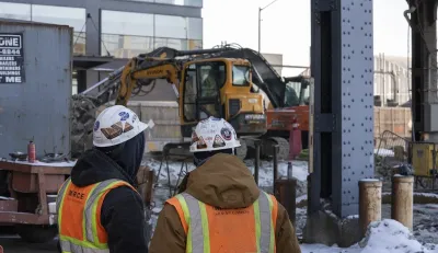 Workers in hard hats looking at Gateway Tunnel construction work.