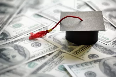 Graduation mortarboard on a pile of money.
