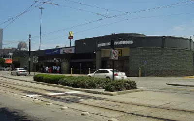 Greyhound bus station in Houston, Texas next to street with light rail tracks.