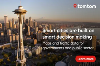 A TomTom advertisement over an image of Seattle's space needle at golden hour