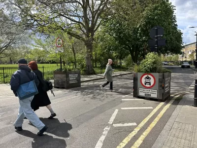 Two planters block cars from going onto a low-traffic street.