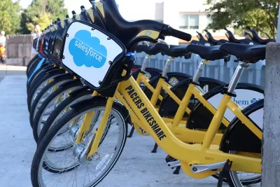 Row of yellow Pacers Bikeshare bikes at station in downtown Indianapolis, Indiana.