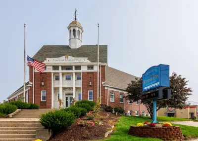 Red brick building with white columns in front for town hall in Rhode Island.