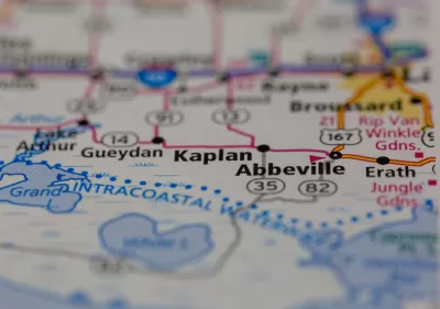 A map depicting a row of cities long a highway, focusing on the city of Kaplan with surrounding cities blurred.