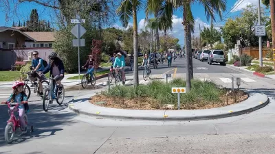 Group of people and kids biking through small roundabout in Long Beach, California.