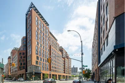 A conceptual rendering of a high-rise apartment building in an urban area.