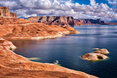 Rock formation along Lake Powell with hosueboat