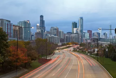 A blur of car taillights illuminate Lake Shore Drive approaching Downtown Chicago.