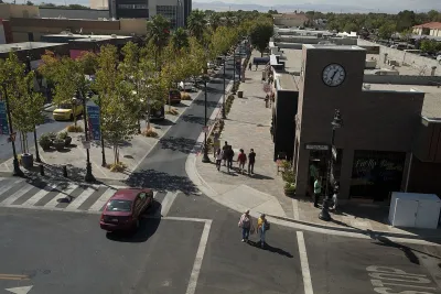 Lancaster Boulevard with tree-lined median and wide sidewalks in Lancaster, California.
