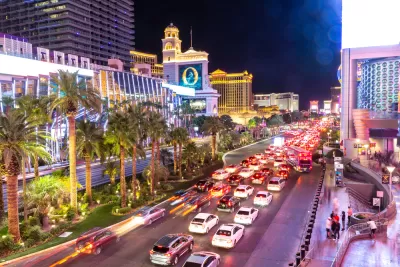 The Las Vegas Strip, pictured at night with lights and illuminated and Las Vegas Boulevard congested with cars.