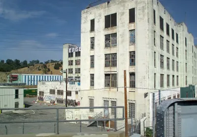 Former Lincoln Heights jail, now abandoned, with graffiti on white Art Deco stone walls in Los Angeles, California.