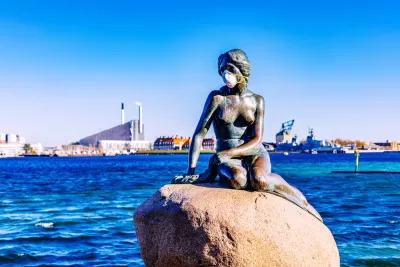 A statue of the Little Mermaid, overlooking the waterfront of Copenhagen, Denmark, is adorned with a mask during the Covid-19 pandemic.