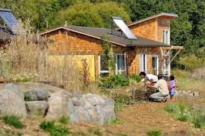 A family gardening in front of a house