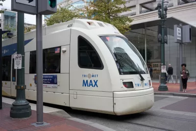 A TriMet MAX Red Line light rail train heading for the Portland International Airport comes to a stop at Pioneer Place in downtown Portland.